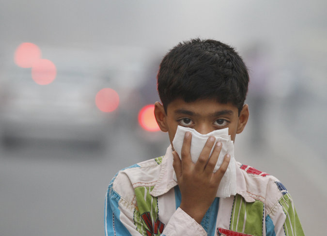 A child tries to protect himself from the air pollution in New Delhi. (PHOTO Sanjeev Verma/Hindustan Times)