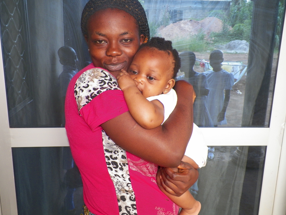 A happy mother jealously holds her healthy baby, thanks to improved health facilities in Limbe, Cameroon (PHOTO: ClimateReporters/Elias Ntungwe)