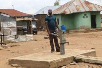 Ataka Terhemba at the dysfunctional public borehole in Iddo Sarki (PHOTO: Mimiola Olaoluwa)