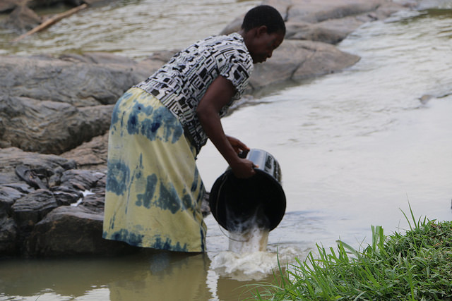 Access to safe water in Iddo Sarki. A woman in the community fetches water from the street. (PHOTO: Mimiola Olaoluwa)