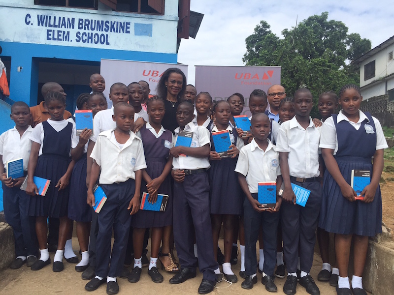 Group Head, Marketing and Corporate Communications, United Bank for Africa( UBA) Bola Atta flanked by pupils of C. William Brumskine elementary school, Monrovia