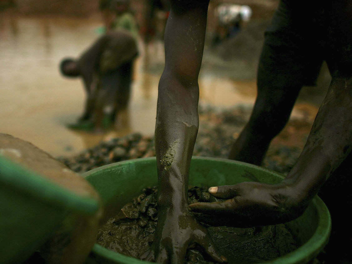 Men sift  through buckets of dirt while looking for gold in Mongbwalu, Congo. Thousands of Congolese scrape together meagre livings from mining. Gold and other mineral deposits, which are numerous in the volatile north-east of the country, have become a catalyst to much of the conflict in Congo. The Democratic Republic of Congo (DRC), a country that loses an estimated 1,400 people per day due to war since 1998, is struggling to hold Presidential elections this summer. The volatile East of the country, which is situated hundreds of miles from the capital Kinshasa, has been the focal point of continued violence. Numerous militias and warlords have vied for control of the mineral rich eastern Congo for decades, creating instability and continued bloodshed.  (Photo by Spencer Platt/Getty Images)