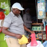 John Murimi sells fertilizer at his Agrovet shop at Kagio market in Kenya’s Kirinyaga County